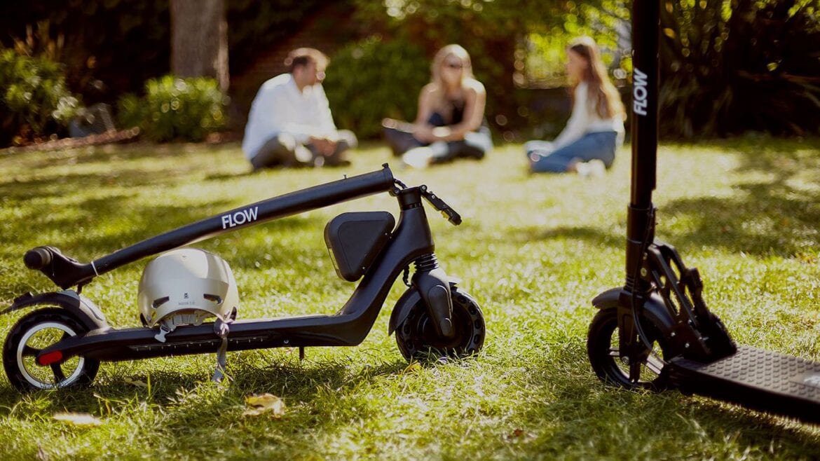 Flow Electric Scooters in park with people having pick nick